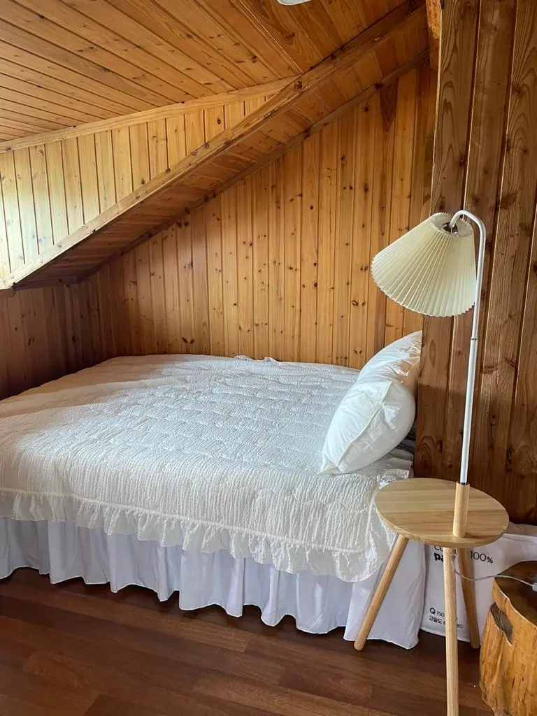 An upstairs bedroom under the timber ceiling